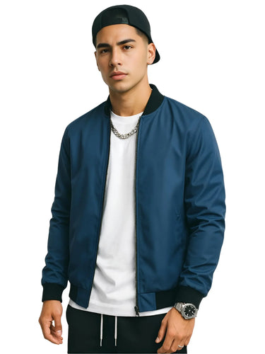 Man wearing a blue bomber jacket, white shirt, black pants, and black cap on a white background